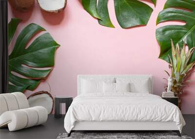 Tropical leaves and exotic fruits summer concept frame on the pink background. Top view. Copy space Wall mural