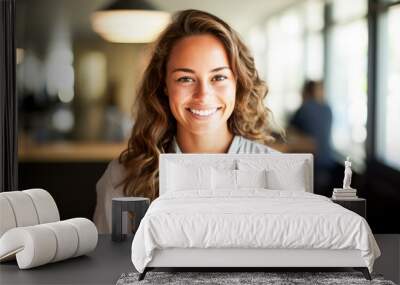 Smiling young woman standing at blurred office background Wall mural