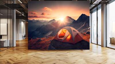 Tourist tent camping in mountains at sunset Wall mural