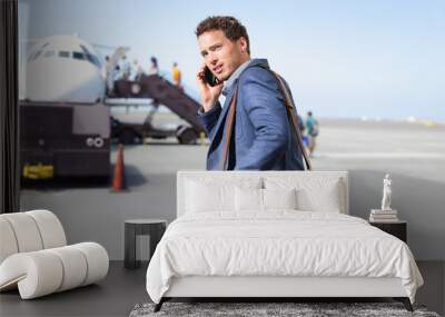 airport business man on smartphone by plane Wall mural