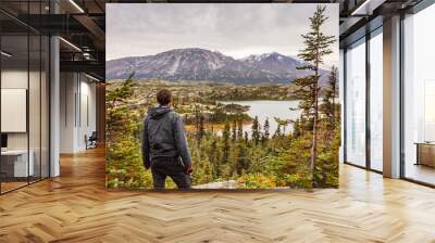 Alaska hiking man travel outdoor lifestyle, Young traveler hiker at mountains landscape in autumn. Wall mural