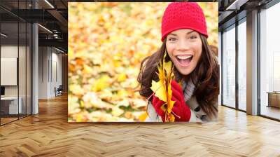 Asian Autumn woman holding fall leaves in forest Wall mural