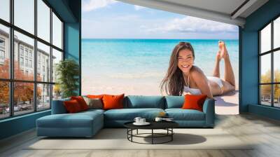 Asian bikini model woman relaxing sunbathing on white sand on paradise beach tropical travel, blue ocean background. Travel holiday girl relaxing on Caribbean beach summer vacation. Wall mural