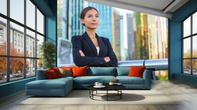 Asian businesswoman confident looking away contemplating career city job work. Multiracial ethnic Chinese Caucasian young business woman portrait pensive professional in black suit with crossed arms. Wall mural