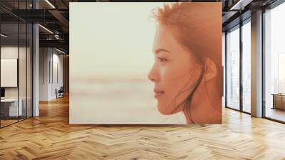 Asian woman beauty portrait serene on beach at sunset looking at ocean pensive -Panorama banner face of chinese girl happy. Wall mural