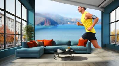 athlete running man - male runner in san francisco Wall mural