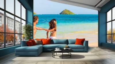 Beach summer vacation happy young tourists lovers on Hawaii vacation travel. Man and woman holding hands in the Sun. Landscape Panoramic banner people lifestyle. Wall mural