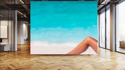 Beach vacation bikini woman relaxing banner with blue water texture copyspace background. Travel holiday panorama concept, girl sunbathing with sun hat lying down on sand. Tropical holidays. Wall mural