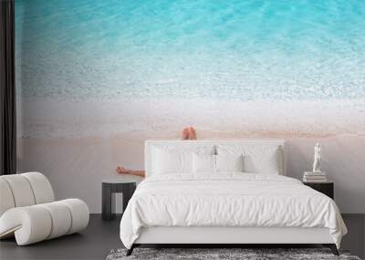 Beach vacation dream Caribbean travel destination bikini woman sunbathing relaxing lying down on pink sand drone view banner landscape of blue waves of water. Wall mural