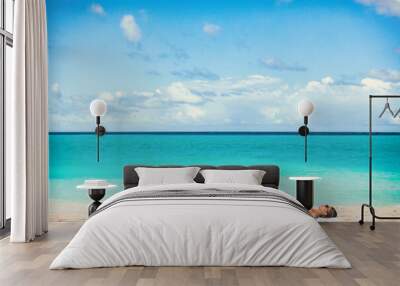 Beach vacation summer suntan girl relaxing sunbathing on blue ocean background. Wall mural