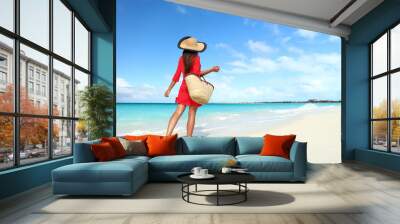 beachwear woman tourist with straw sun hat and beach bag walking on tropical summer vacation wearing Wall mural