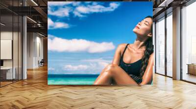 Beauty Asian woman relaxing sun tan on beach banner panoramic ocean blue sky background. Sun care body sunscreen solar protection sunbathing face. Wall mural