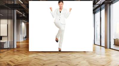 Business woman celebrating happy and cheerful in white suit in full body. Cheering winner gesturing in joyful dance over success. Young multiracial Chinese Asian and Caucasian businesswoman isolated i Wall mural