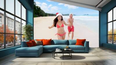 Christmas couple happy relaxing on beach travel Wall mural