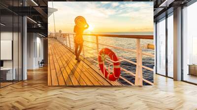 Cruise ship luxury vacation travel woman watching sunset on deck. Elegant lady tourist with sun hat relaxing on Caribbean holidays. Wall mural