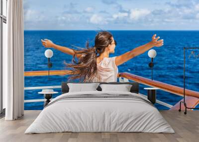 Cruise ship vacation woman enjoying travel vacation having fun at sea. Free carefree happy girl looking at ocean with open arms in freedom pose. Wall mural