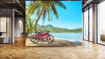 Cycling tourism e-bike bikes biking tour excursion tourists summer vacation travel landscape. Tahiti island bicycles on beach. Wall mural