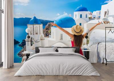 Europe travel happy vacation woman. Girl tourist having fun with open arms in freedom in Santorini cruise holiday, summer european destination. Red dress and hat person. Wall mural