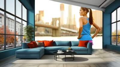 fitness woman runner relaxing after city running Wall mural