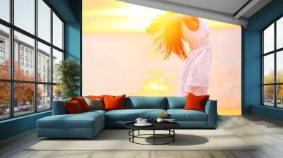 free woman enjoying freedom feeling happy at beach Wall mural