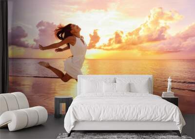 freedom wellness well-being happiness concept. happy carefree asian woman feeling blissful jumping o Wall mural