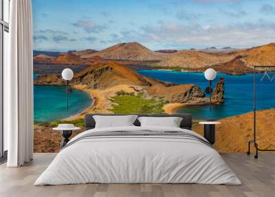 Galapagos islands travel banner. Bartolome Island, volcanic islet in the Islas Galapagos archipelago. Panoramic view of Sullivan bay, golden beach and Santiago island from hiking on cruise excursion. Wall mural