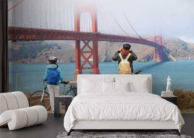 golden gate bridge - biking couple sightseeing Wall mural