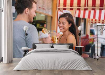 Happy couple eating sandwiches in typical retro cafe in Florida. Cuba sandwich local food. Summer travel tourist lifestyle young Asian woman smiling eating lunch outside. Wall mural