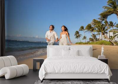 happy couple relaxing running together having fun during sunset on tropical beach. summer travel des Wall mural