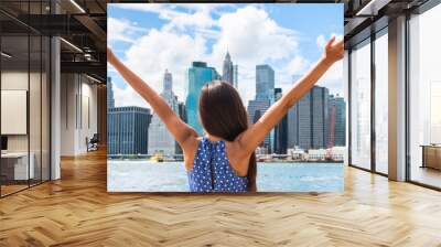 Happy free woman with arms up at NYC New York city skyline with arms outstretched raised in the sky. Success in life, winning tourist on travel holiday. Banner panorama header crop. Wall mural