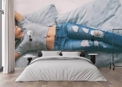 Happy girl relaxing at home healthy lifestyle Asian woman relax lying down on living room floor pillows enjoying life in condo banner panorama. New apartment homeowner enjoying house. Wall mural