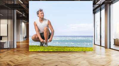 Happy healthy man getting ready to walk or jog on summer beach - Active lifestyle for weight loss runner going running outside. Wall mural