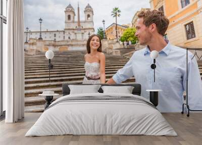 Happy romantic couple holding hands on Spanish Steps in Rome, Italy. Joyful young interracial couple walking on the travel landmark tourist attraction on romance Europe holiday vacation. Wall mural