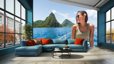 Happy woman cruising towards the deux gros pitons, popular tourist attraction in St Lucia. World Heritage site. Young traveler relaxing on shore excursion boat tour from cruise ship vacation travel. Wall mural