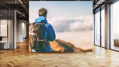 Hiker travel lifestyle young man wearing jacket and backpack on trek trip outdoor in mountains. Wall mural