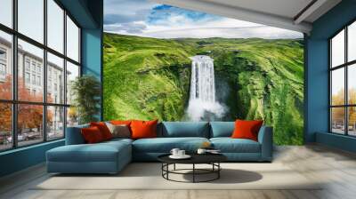 Iceland waterfall Skogafoss in Icelandic nature landscape. Famous tourist attractions and landmarks destination in Icelandic nature landscape on South Iceland. Aerial drone view of top waterfall. Wall mural