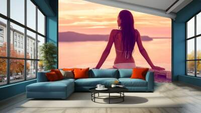 Luxury hotel swimming pool bikini model woman relaxing in jacuzzi spa with Mediterranean sea view at sunset. Girl coming out of water with healthy long hair, body care wellness concept. Wall mural