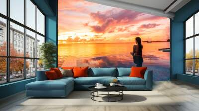 Paradise sunset idyllic vacation woman silhouette swimming in infinity pool looking at sky reflections over ocean dream. Perfect amazing travel destination in Bora Bora, Tahiti, French Polynesia. Wall mural