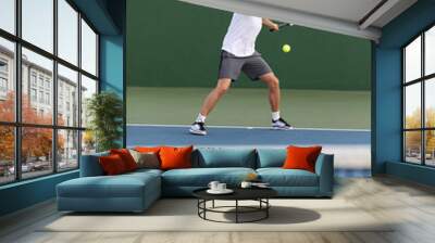 Professional tennis player athlete man hitting forehand ball over net on hard court playing tennis match. Sport game fitness lifestyle. Wall mural