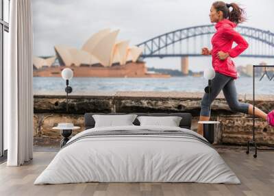 Runner fit active lifestyle woman jogging on Sydney Harbour by the Opera house famous tourist attraction landmark. City life. Wall mural