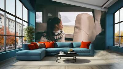 RV camper van travel Asian girl sitting in back of motorhome car on Iceland road trip. Europe vacation lifestyle. Wall mural