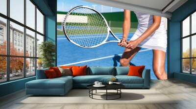 Tennis player woman ready playing game on blue hard court holding racket in position wearing white dress skirt. Female athlete sport girl in summer sports activity class. Wall mural