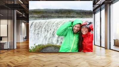 Travel couple fun by Dettifoss waterfall, Iceland Wall mural