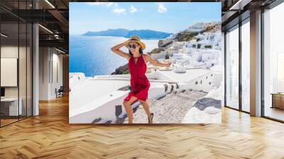 Travel Tourist Happy Woman Running Stairs Santorini, Greek Islands, Greece, Europe. Girl on summer vacation visiting famous tourist destination having fun smiling in Oia. Wall mural