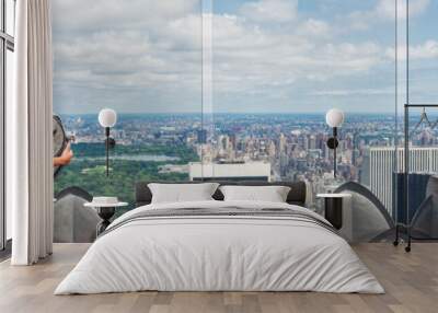 USA travel tourist in New York City vacation- woman looking at view of skyline with binoculars from skyscraper. Girl traveling summer holidays United States road trip Wall mural