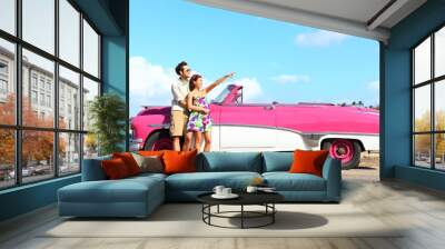 Vintage car - couple pointing Wall mural