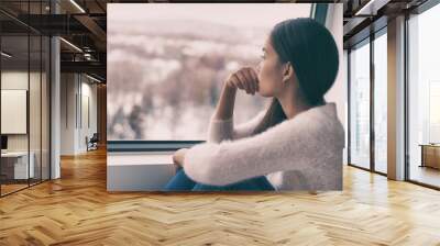 Winter depression - seasonal affective disorder mental health woman sad comtemplative looking out the window alone. Wall mural