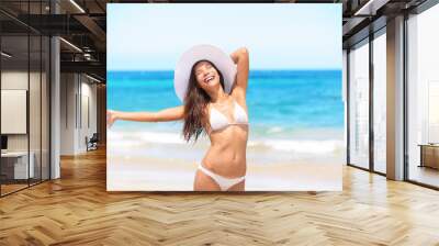 Woman on beach enjoying sun happy on travel Wall mural