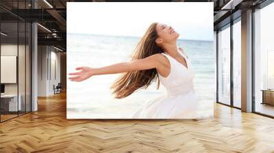 Woman relaxing at beach enjoying summer freedom Wall mural