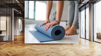 Yoga at home woman rolling exercise mat in living room of house or apartment condo for morning wellness yoga practice. Wall mural